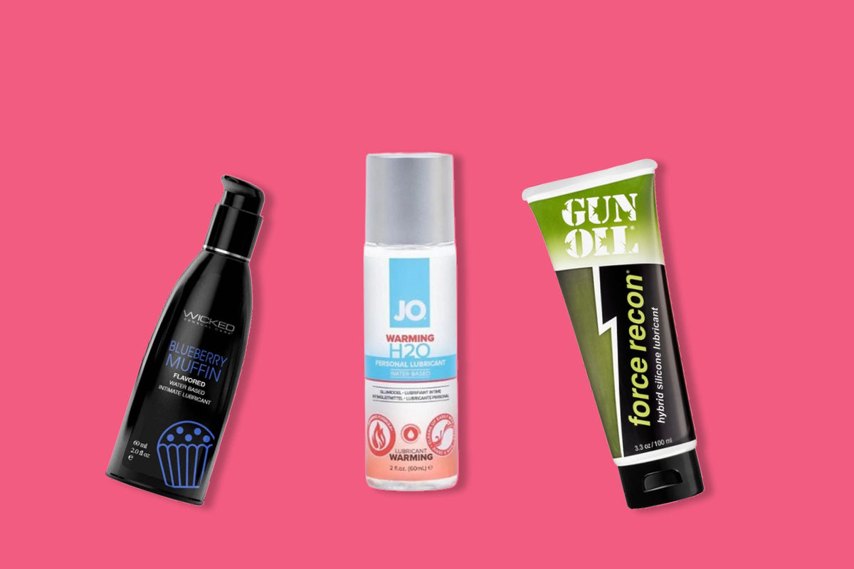 Three top lubes displayed against a pink background including Wicked Blueberry Muffin flavored lubricant, JO H2O Warming lubricant, and Gun Oil Force Recon hybrid silicone lubricant.