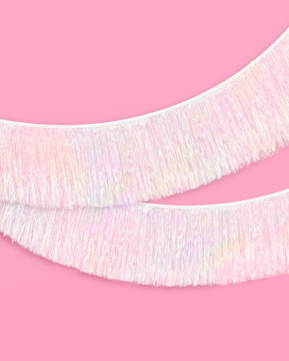 White iridescent foil tinsel fringe banner used as a party backdrop