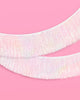 White iridescent foil tinsel fringe banner used as a party backdrop