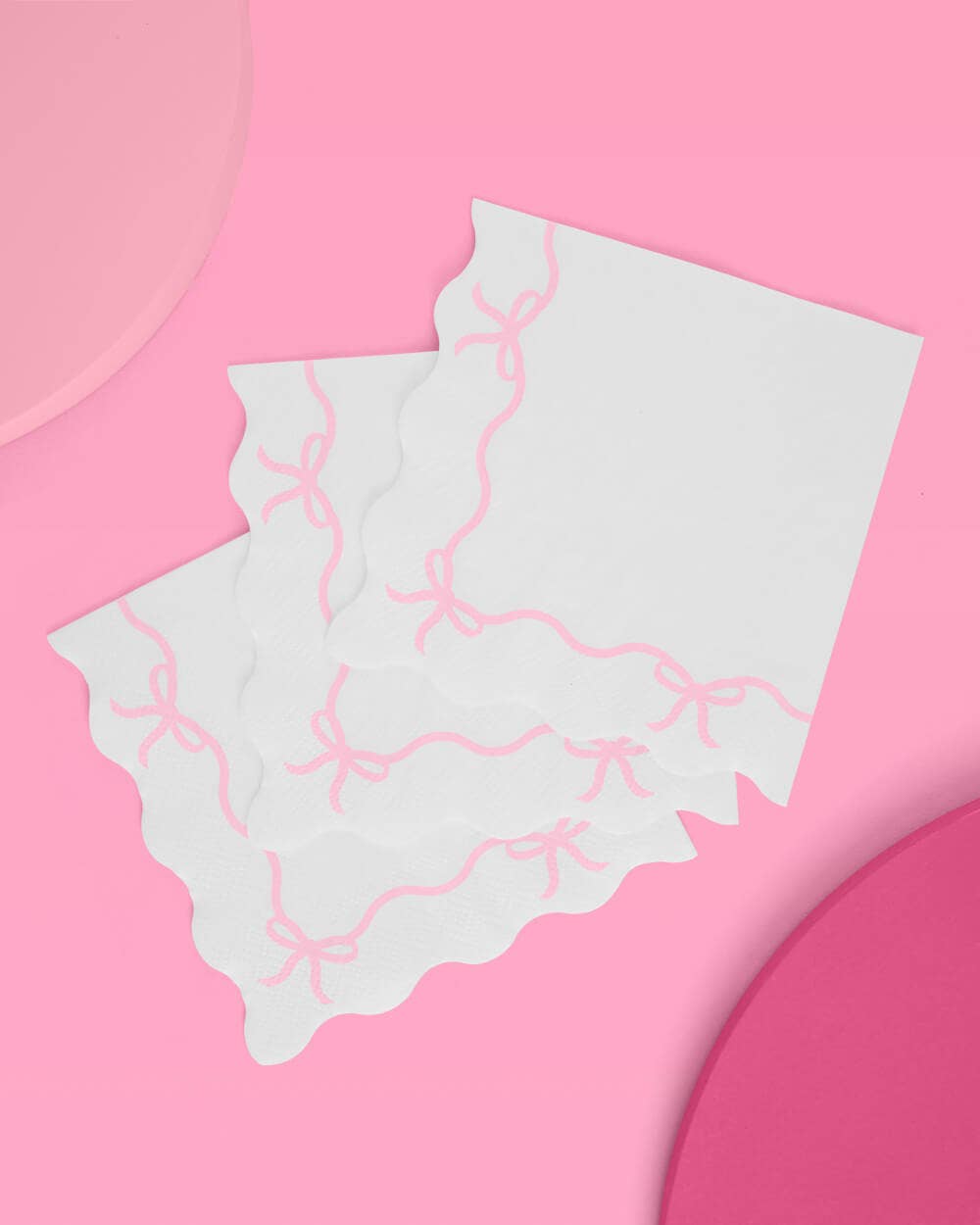 Pastel pink paper napkins with a dainty bow design