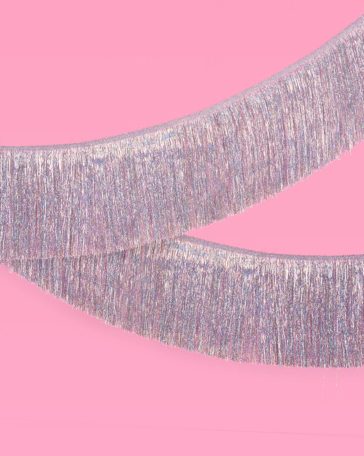 Pastel rainbow iridescent fringe garland hung as party decor