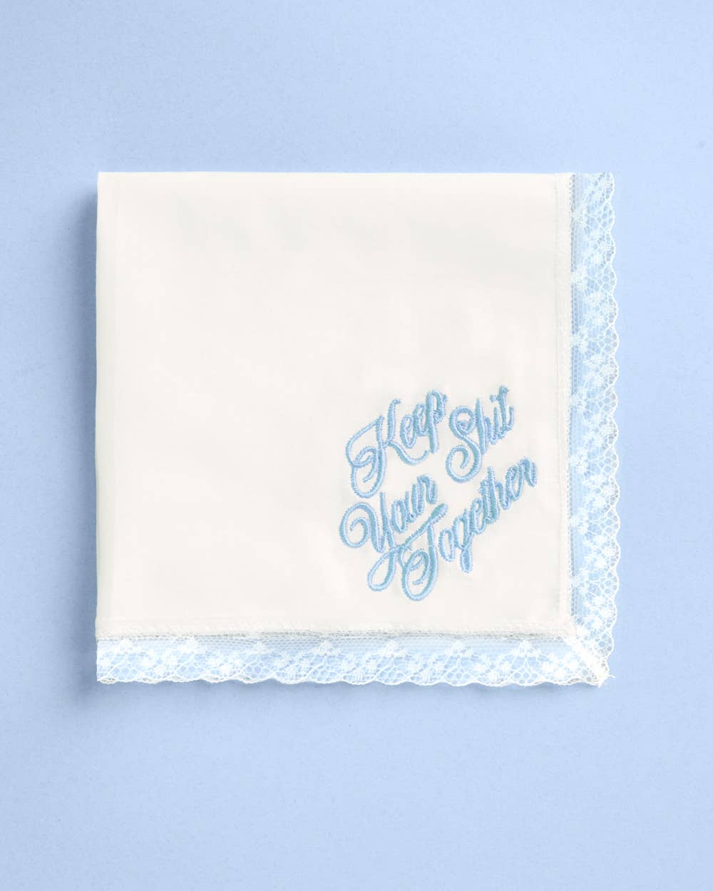 White lace trimmed handkerchief with bold blue embroidered lettering