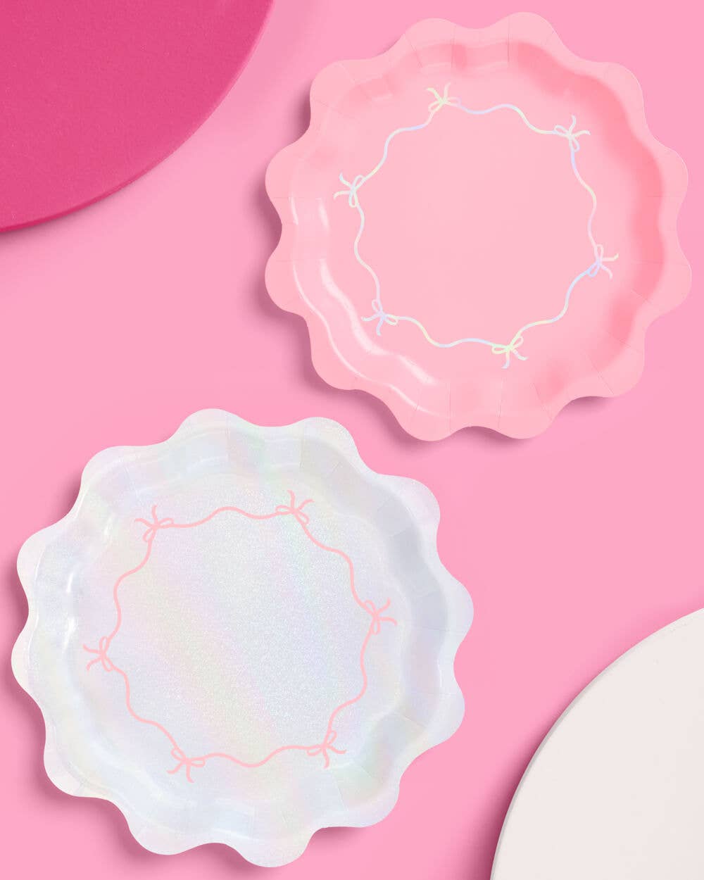 Iridescent and pink paper party plates with bow detailing