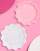 Iridescent and pink paper party plates with bow detailing