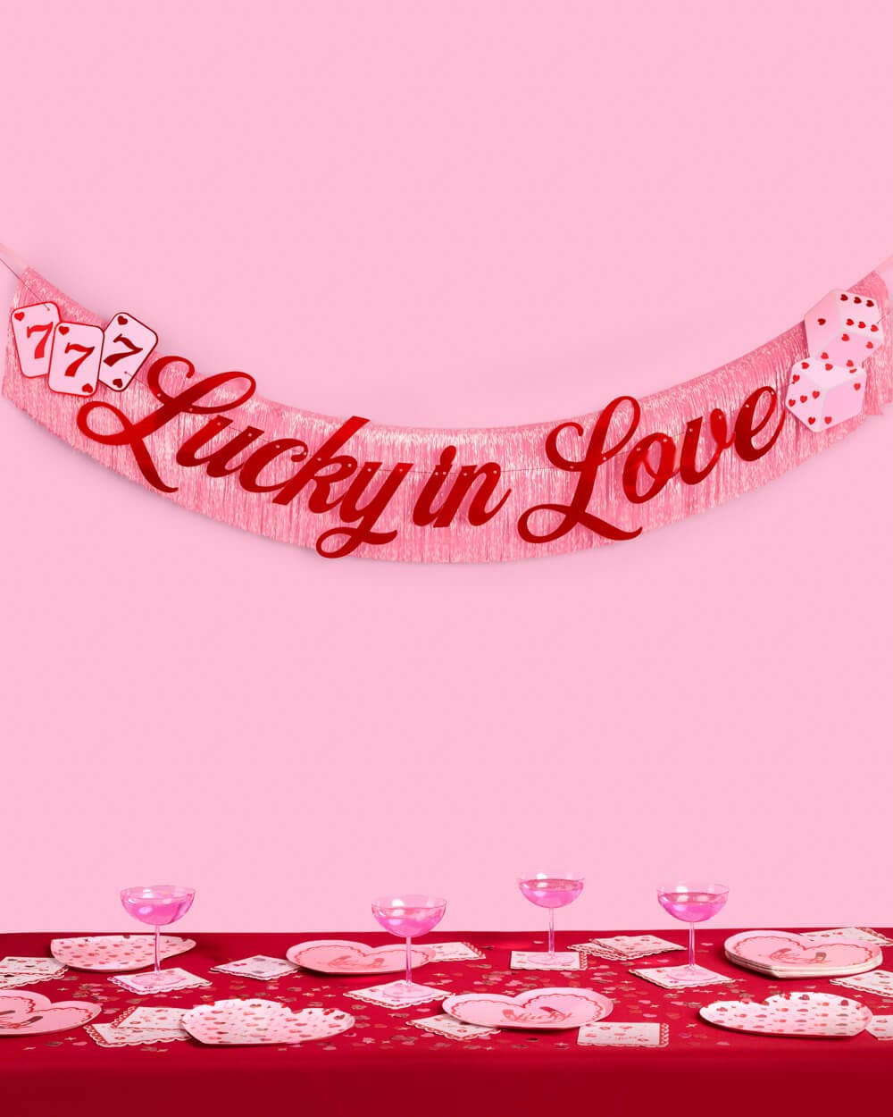 Pink iridescent fringe banner with red foil Lucky in Love lettering