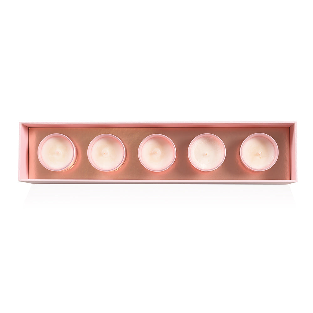 Top view of five HighOnLove mini massage candles in their tray