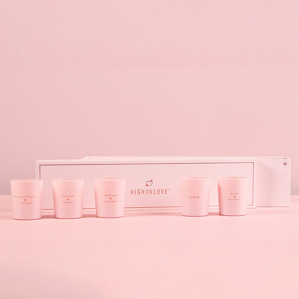 HighOnLove Mini Sensual Massage Candles Collection displayed with its box on pink