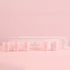 HighOnLove Mini Sensual Massage Candles Collection displayed with its box on pink