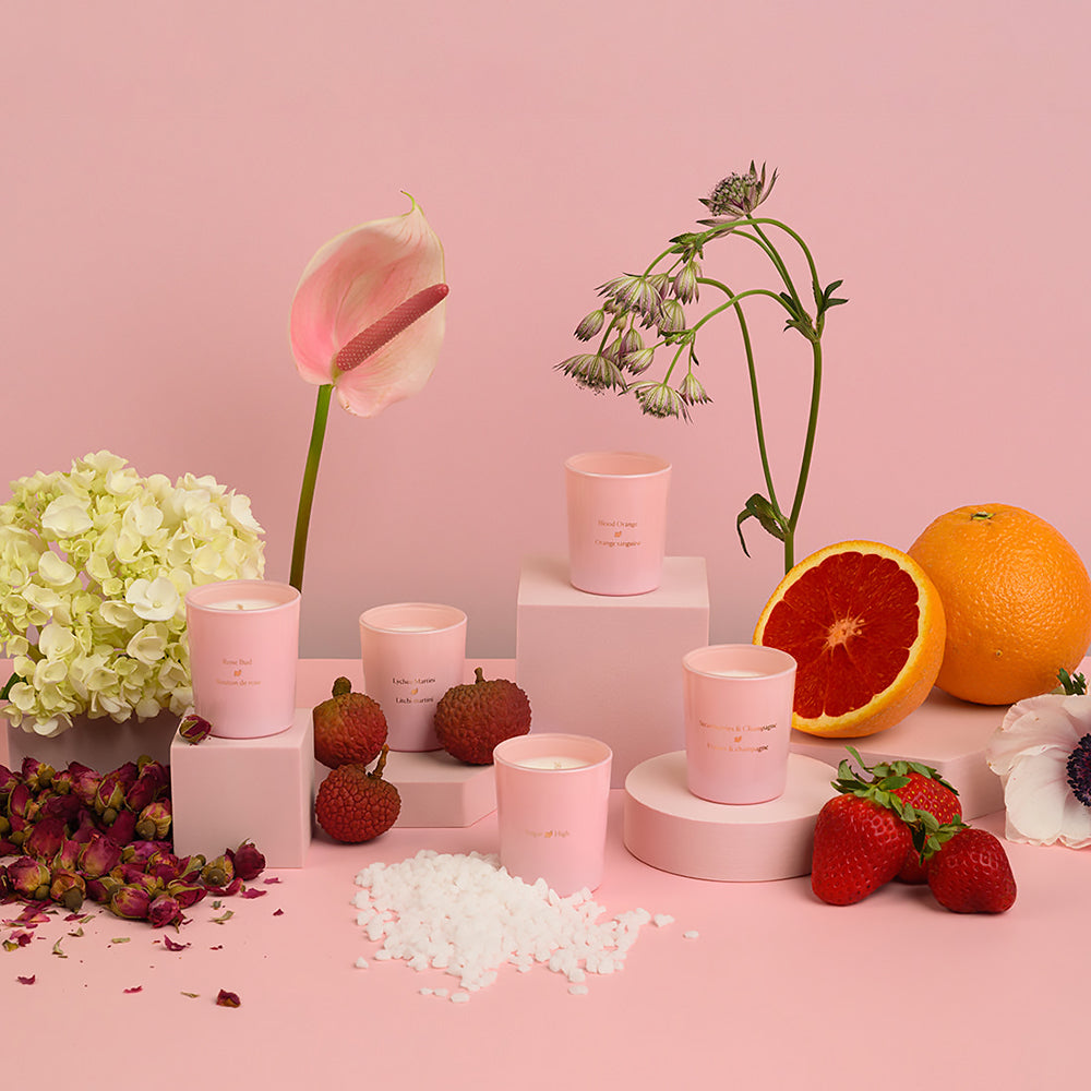 HighOnLove mini massage candles styled with strawberries, blood orange and rose buds