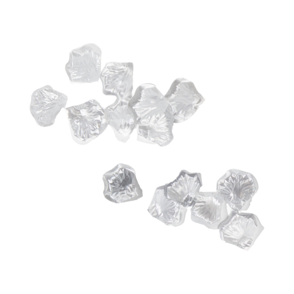 Silver silk rose petals scattered on white