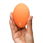 We-Vibe Temp Lay-On Vibrator – Tangerine, held in hand