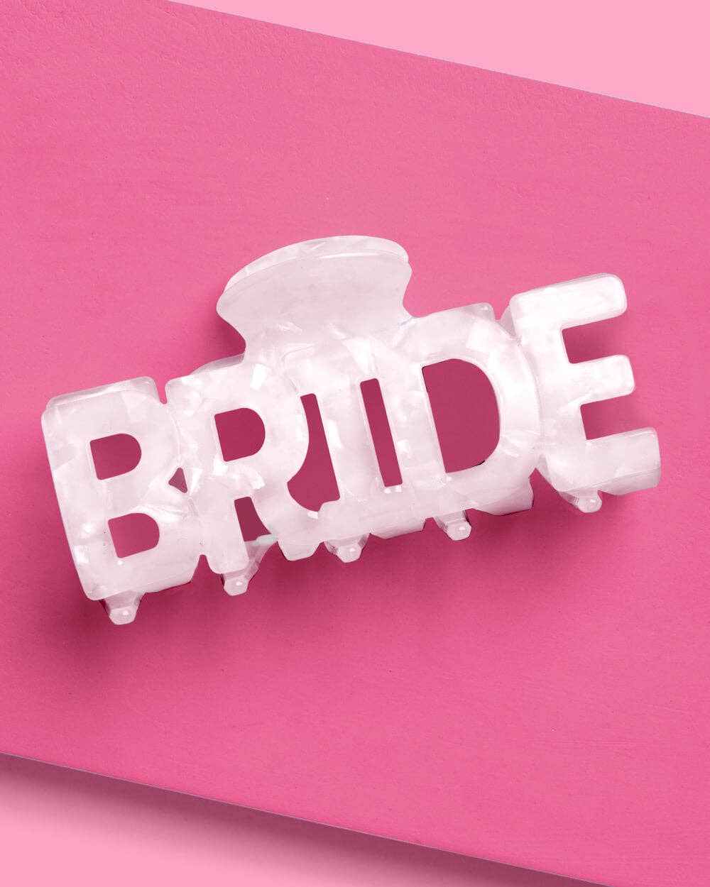 White marble acrylic claw clip shaped from the word BRIDE