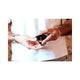 Two men's hands passing the black diamond parfum bottle between them