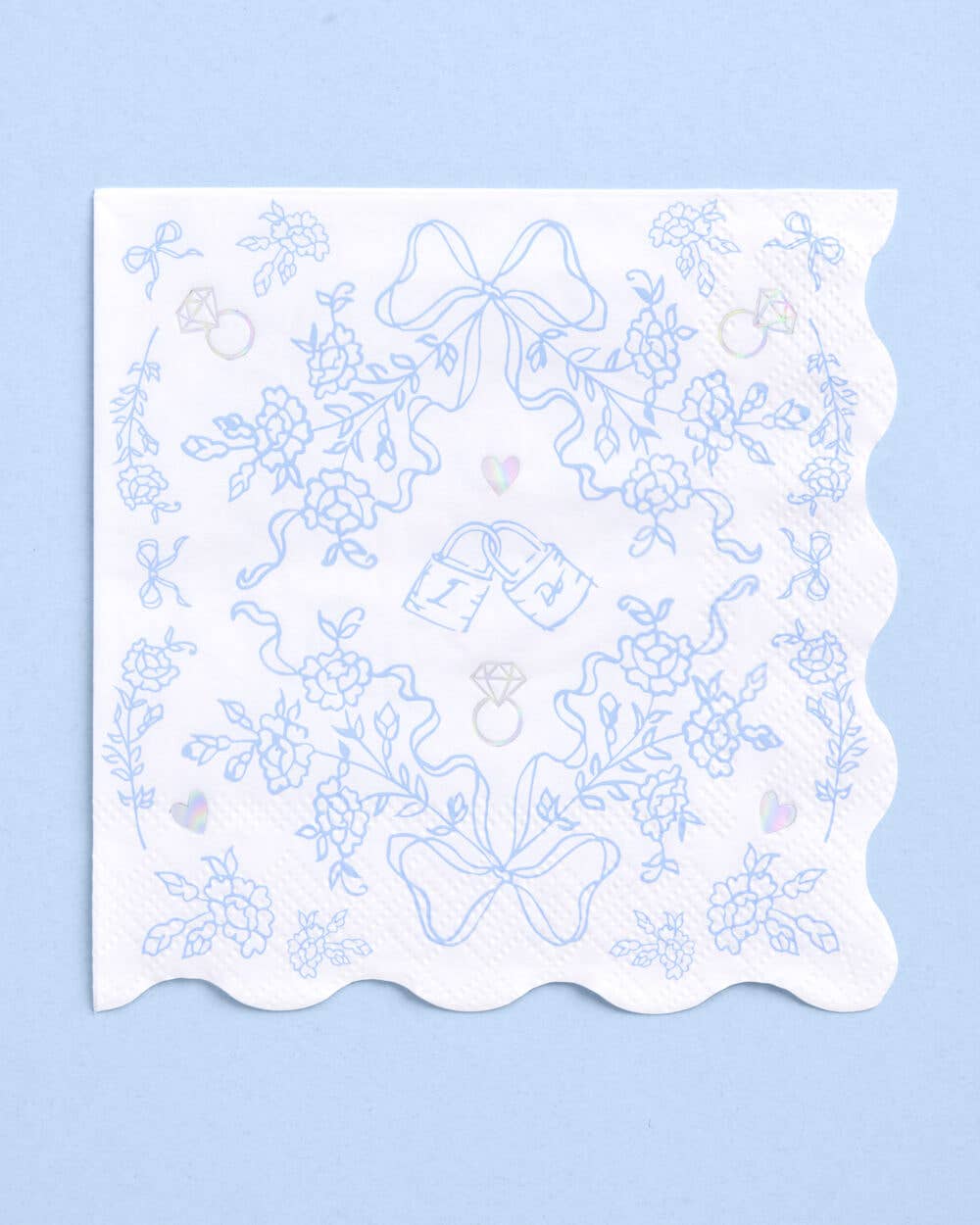 White cocktail napkins with blue and iridescent foil bridal illustrations and wavy edges