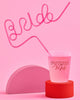 Oversized neon pink plastic straw spelling Bride