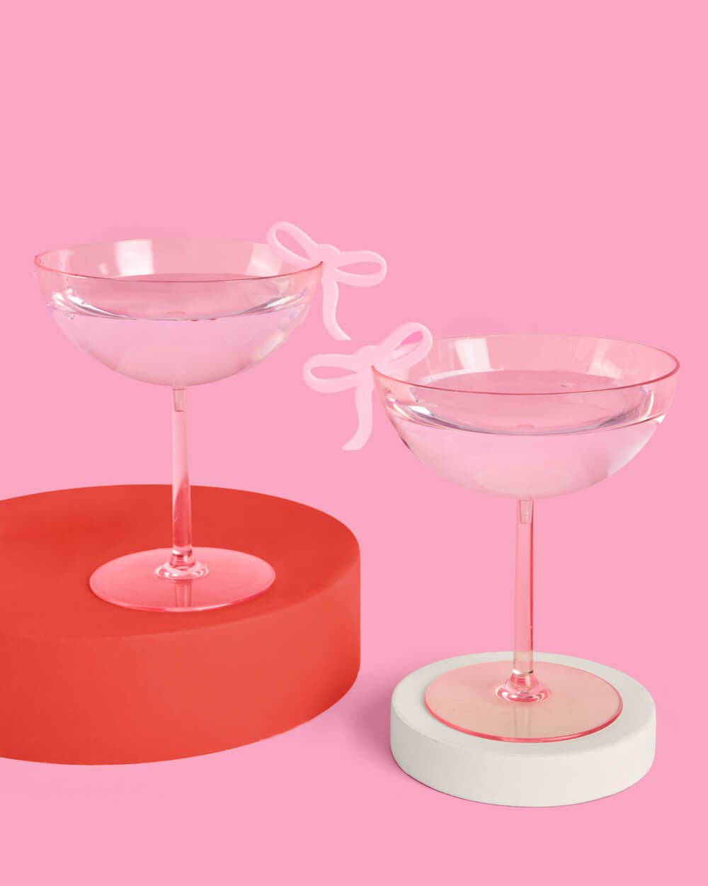 Pink acrylic bow shaped drink markers on glassware