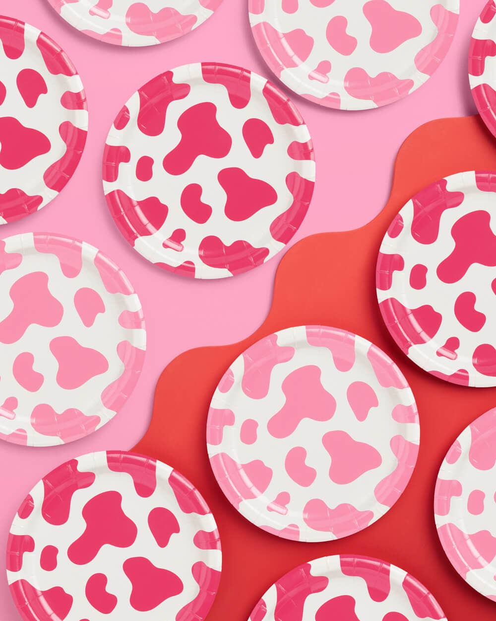 Pink cow print paper party plates in two shades