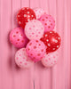 Matte latex balloons printed with cherries, kisses, and sparkle icons