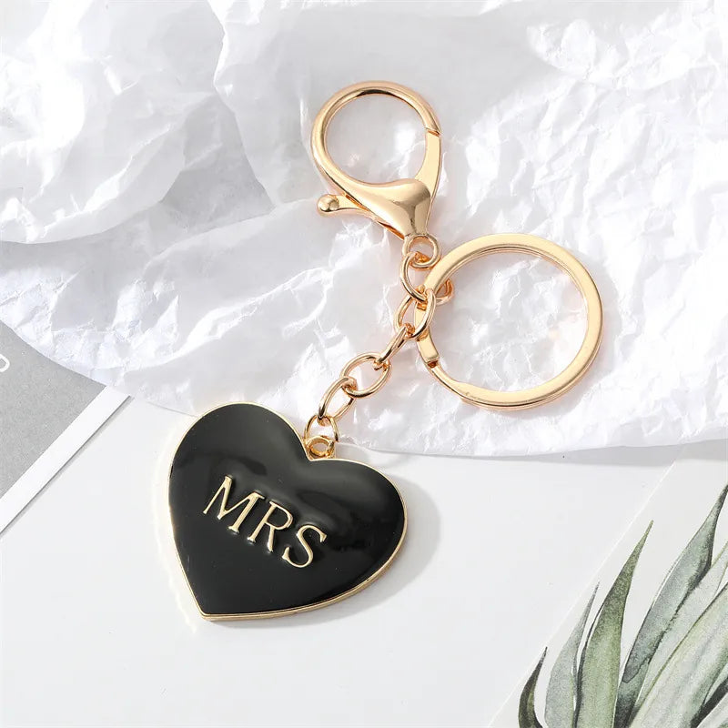 Black enamel heart keychain with gold MRS lettering