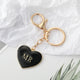 Black enamel heart keychain with gold MR lettering