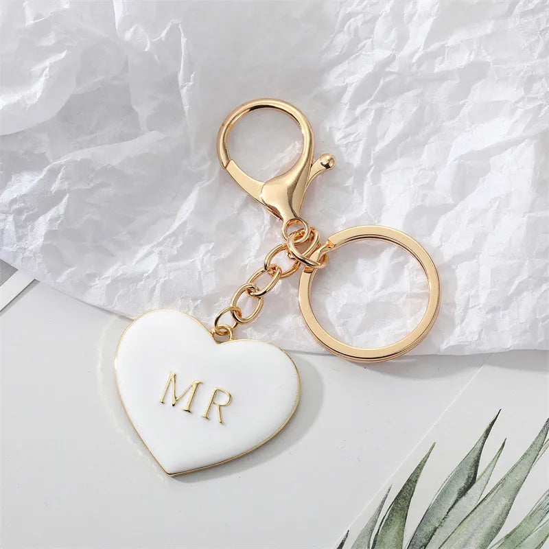White enamel heart keychain with gold MR lettering