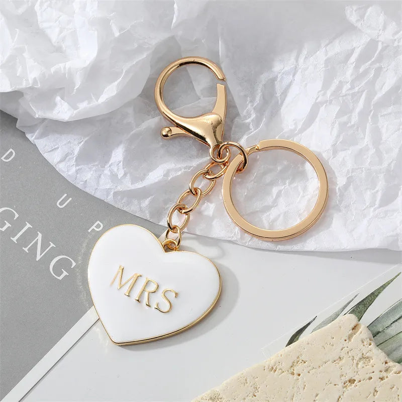 White enamel heart keychain with gold MRS lettering