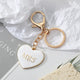 White enamel heart keychain with gold MRS lettering