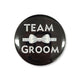 Black 58mm tinplate pin badge reading TEAM GROOM