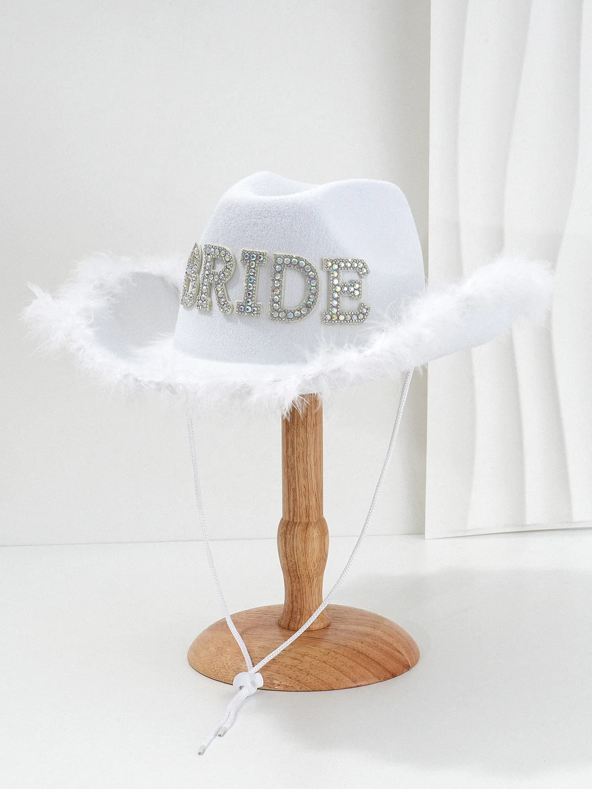 White felt bride cowboy hat with rhinestone lettering and feather fringe