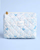 White diamond quilted cosmetic bag with blue floral print and gold heart zipper