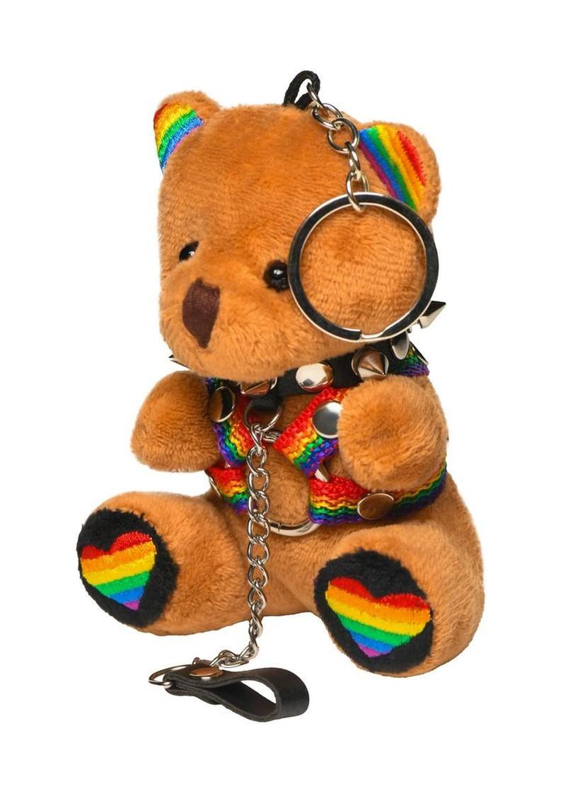 Tan plush pride bear keychain with spiked collar and chain leash, three-quarter front view