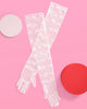 Sheer white bow gloves laid flat at full opera length