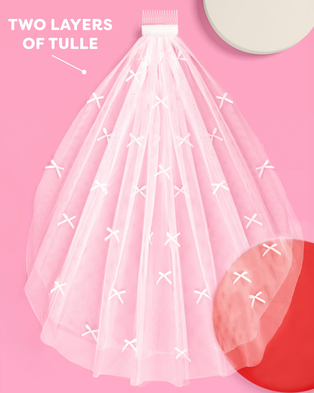 Two layer white tulle veil with mini satin bows laid flat
