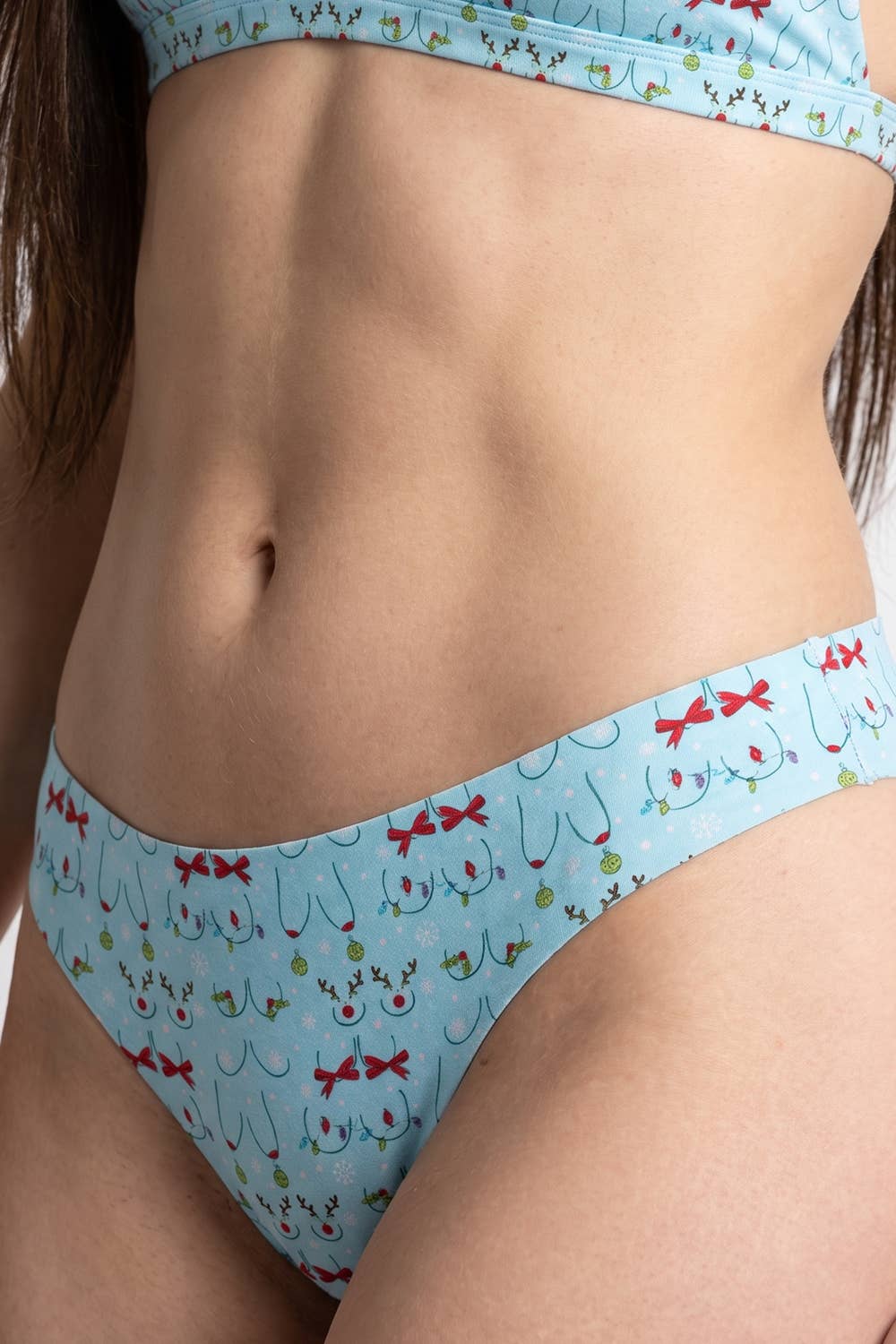 Light blue seamless thong with a Christmas ornament bust print, front view