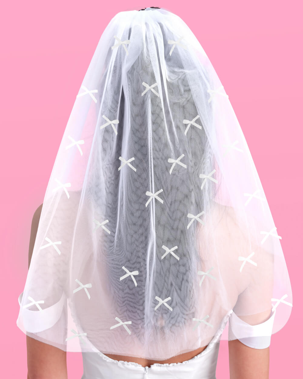 White mini bow veil worn from behind over loose hair